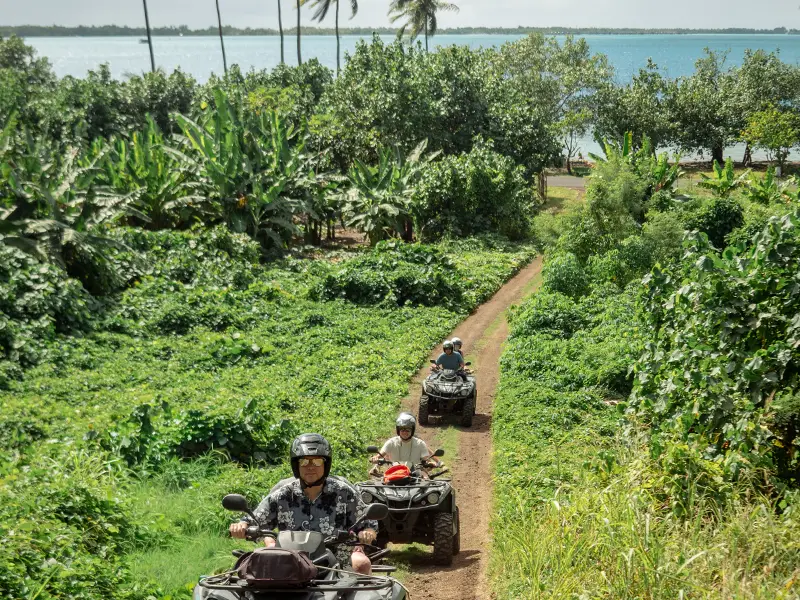 ATV riders on a mountain trail during a Bora Bora quad tour