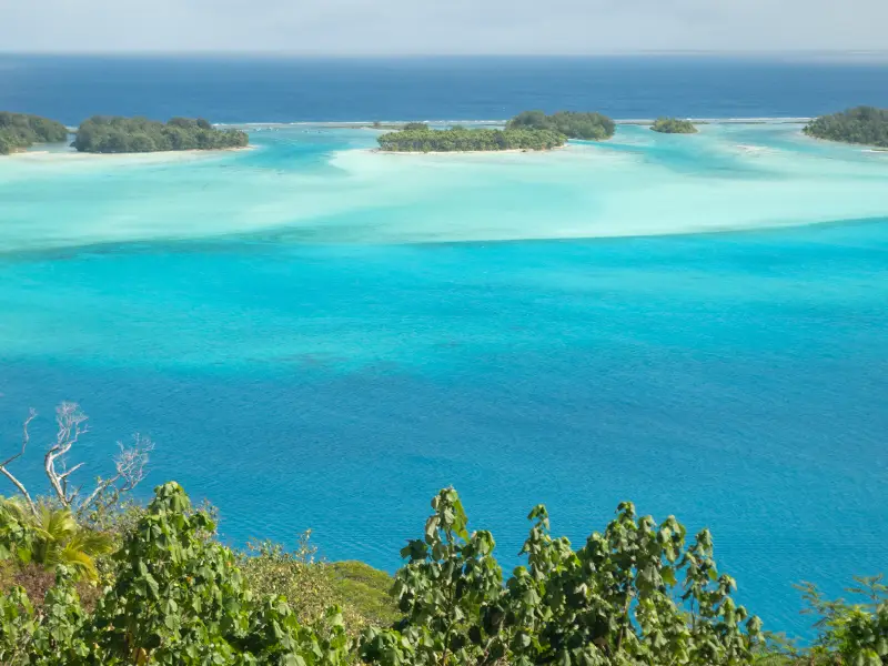 ATV rider on a Mount Popoti trail overlooking the Bora Bora lagoon